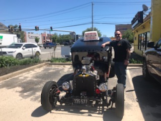All Care instructor with a classic hot rod wearing a student driver sign