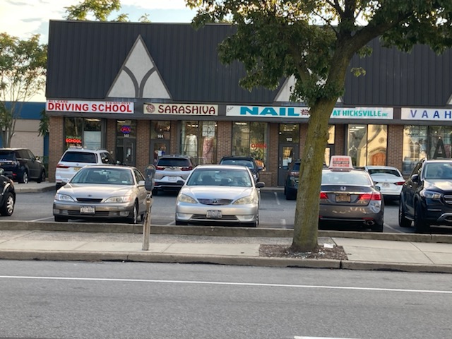All Care Driving School storefront and school cars on Broadway in Hicksville