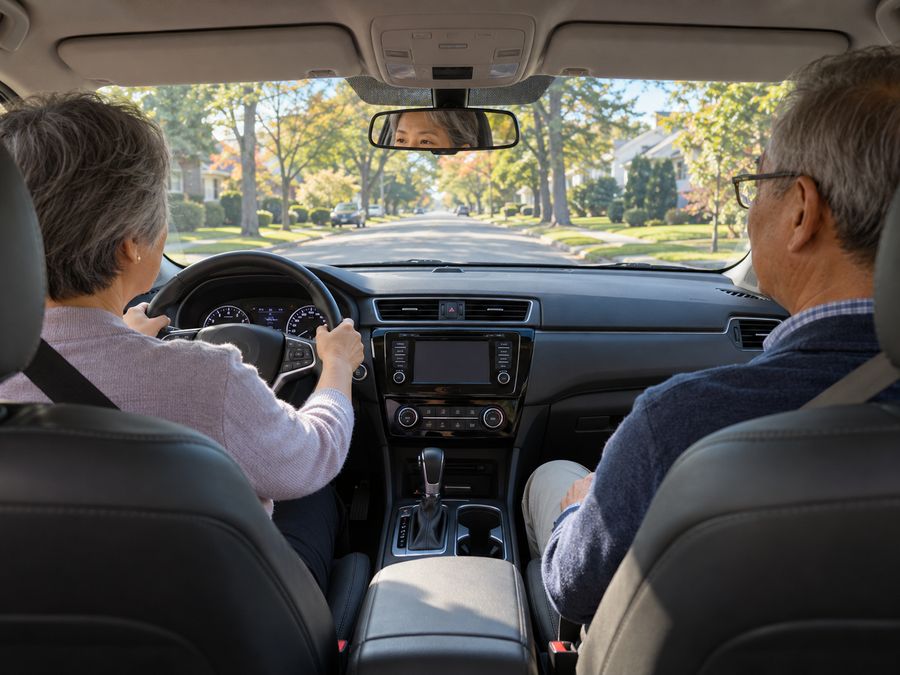Senior driver at the wheel on a suburban Long Island street